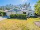 Charming single-story home featuring well-manicured lawn, mature trees, and an attached two-car garage at 2936 Suber St, The Villages, FL 32163