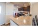 Modern kitchen featuring stainless steel appliances and a breakfast bar that opens to the dining area at 2936 Suber St, The Villages, FL 32163