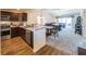 Modern kitchen featuring stainless steel appliances, warm wood cabinetry, and an open view into the living spaces at 2936 Suber St, The Villages, FL 32163