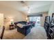 Bright living room with vaulted ceiling, comfortable seating, and sliding glass doors to the outdoor patio at 2936 Suber St, The Villages, FL 32163