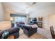 Bright living room with vaulted ceiling, comfortable seating, and sliding glass doors to the outdoor patio at 2936 Suber St, The Villages, FL 32163