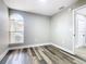 An empty room with light-gray walls, wood floors, and a large window at 3208 Sabal Palms Ct # A, Kissimmee, FL 34747