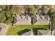 A bird's eye view of the roof and yard of several townhomes in a well-maintained community at 3257 Villa Strada Way, Orlando, FL 32835