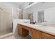 Bright bathroom featuring a double sink vanity with a large mirror and a separate tiled shower at 3257 Villa Strada Way, Orlando, FL 32835