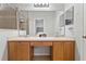 Bright bathroom featuring a double sink vanity with a large mirror and a separate tiled shower at 3257 Villa Strada Way, Orlando, FL 32835