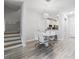 Open dining area with modern light fixture, connecting to the kitchen and staircase at 3257 Villa Strada Way, Orlando, FL 32835