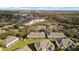 An exterior aerial view of the back of the townhomes, overlooking a beautiful green space at 3257 Villa Strada Way, Orlando, FL 32835