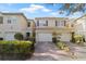 Charming townhome featuring a one-car garage and a beautifully landscaped front yard with a brick paved driveway at 3257 Villa Strada Way, Orlando, FL 32835