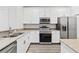 Modern kitchen featuring stainless steel appliances, granite countertops, and white cabinetry at 3257 Villa Strada Way, Orlando, FL 32835