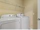 Well-lit laundry room with a modern washer and dryer, plus convenient shelving at 3257 Villa Strada Way, Orlando, FL 32835