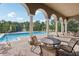 Relax by the pool with shaded seating, perfect for enjoying the outdoors with a view at 3257 Villa Strada Way, Orlando, FL 32835