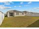 Large backyard with a grassy lawn and a patio area at 337 Regency Ridge Dr, Davenport, FL 33837