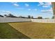 Spacious grassy backyard enclosed by a white fence, perfect for outdoor activities at 337 Regency Ridge Dr, Davenport, FL 33837