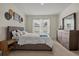 Comfortable bedroom featuring a queen-size bed, dresser, and decorative wall art at 337 Regency Ridge Dr, Davenport, FL 33837