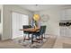 Cozy dining area with a wooden table, stylish blue chairs, and modern light fixture at 337 Regency Ridge Dr, Davenport, FL 33837