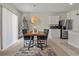 Dining area featuring a wooden table, seating for four, and a view of the kitchen appliances at 337 Regency Ridge Dr, Davenport, FL 33837