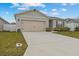 Well-maintained single Gathering home with an attached two-car garage and concrete driveway at 337 Regency Ridge Dr, Davenport, FL 33837