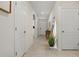 Bright hallway with neutral paint, tile flooring, and an arched doorway at 337 Regency Ridge Dr, Davenport, FL 33837