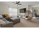 Comfortable living room featuring a gray sectional, egg chair, and entertainment center at 337 Regency Ridge Dr, Davenport, FL 33837