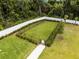 Aerial view of a fenced dog park with lush landscaping, a sidewalk, and ample space at 3380 Private Oak Dr, Apopka, FL 32703