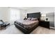 Main bedroom with a large, tufted headboard, neutral bedding, and natural light from a window at 3380 Private Oak Dr, Apopka, FL 32703