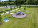 Aerial shot of a playground featuring slides, picnic tables, and lush landscaping at 3380 Private Oak Dr, Apopka, FL 32703