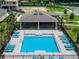 Aerial view of a community pool with ample seating and a nearby shaded pavilion at 3380 Private Oak Dr, Apopka, FL 32703