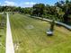 An aerial view of a neighborhood recreational field with trees and seating at 3380 Private Oak Dr, Apopka, FL 32703