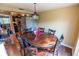 Dining room area with hardwood floors, a decorative table, and adjacent to the kitchen at 3624 Chelsea St, Orlando, FL 32803