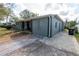 Side view of single-story home featuring well-kept landscaping, and a paved driveway and walkway at 3624 Chelsea St, Orlando, FL 32803