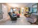 Cozy living room with tile floors, comfortable seating, and ample natural light streaming through the windows at 3624 Chelsea St, Orlando, FL 32803