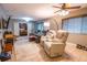 Open living room area with tile floors, inviting seating, and a seamless transition to the adjacent bedroom at 3624 Chelsea St, Orlando, FL 32803