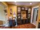 Home office boasts built-in shelving and desk, adjacent to the kitchen area at 3624 Chelsea St, Orlando, FL 32803