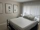 Bedroom with a metal bed frame, decorative pillows, neutral decor, and natural light at 3807 March Ave, Orlando, FL 32806