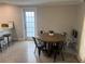 Cozy dining area with a round wooden table, four chairs, and a plant centerpiece by the window at 3807 March Ave, Orlando, FL 32806