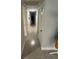 Hallway featuring neutral carpet and trim, with access to several rooms and ample lighting at 3807 March Ave, Orlando, FL 32806