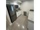 A well-lit kitchen featuring stainless steel appliances, white cabinetry, and granite countertops at 3807 March Ave, Orlando, FL 32806