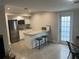 Modern kitchenette with granite countertop, stainless steel appliances, and bar stool seating at 3807 March Ave, Orlando, FL 32806