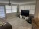 Bright living room with tile floors and large windows, and a view of the backyard at 3807 March Ave, Orlando, FL 32806