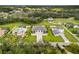 Expansive aerial view of a luxury home featuring a manicured lawn, modern architecture, and serene landscaping at 3845 S Stillwood Ln, Lake Mary, FL 32746