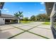 Long driveway showcasing geometric design, lush lawns, and access to the home's garage at 3845 S Stillwood Ln, Lake Mary, FL 32746