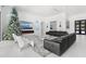 Bright living room with sleek furniture, contemporary fireplace, and a decorative Christmas tree at 3845 S Stillwood Ln, Lake Mary, FL 32746