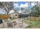 Spacious backyard featuring a brick fire pit and view of the screened in pool at 388 Winnway St, Apopka, FL 32712