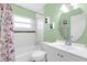 Bright bathroom with subway tiled walls, floral shower curtain and storage under the vanity at 388 Winnway St, Apopka, FL 32712