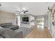 Open living room with wood plank accent wall, tile flooring, and a view of the kitchen at 388 Winnway St, Apopka, FL 32712