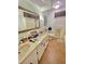 Well-lit bathroom with a double vanity and an expansive mirror, neutral colored tile at 3913 Rose Of Sharon Dr, Orlando, FL 32808