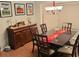 Formal dining room with a dark wood table, chandelier, and elegant buffet at 3913 Rose Of Sharon Dr, Orlando, FL 32808