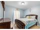 Relaxing bedroom with a wooden bed frame, neutral-colored walls, and natural light from the window at 411 Ridges Dr, Dundee, FL 33838