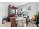 Bright dining room with a decorative china cabinet and a window overlooking the outside at 411 Ridges Dr, Dundee, FL 33838