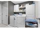 Practical laundry room with a washer, dryer, storage shelves, and a folding area at 411 Ridges Dr, Dundee, FL 33838